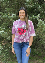 Load image into Gallery viewer, Our Wild Side Tee is a soft to the touch Purple bleach dyed tee. She features a printed design that reads, &quot;Never Hide your Wild Side.”   These shirts are hand dyed. Color, bleach, and dye pattern will vary on each shirt.
