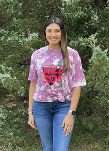 Our Wild Side Tee is a soft to the touch Purple bleach dyed tee. She features a printed design that reads, "Never Hide your Wild Side.”   These shirts are hand dyed. Color, bleach, and dye pattern will vary on each shirt.