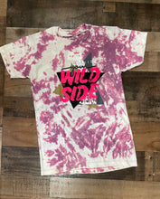Load image into Gallery viewer, Our Wild Side Tee is a soft to the touch Purple bleach dyed tee. She features a printed design that reads, &quot;Never Hide your Wild Side.”   These shirts are hand dyed. Color, bleach, and dye pattern will vary on each shirt.
