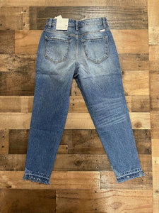 Who doesn't love a great pair of statement jeans? You are going to love our Set in Her Ways Kan Can jeans. They are a medium wash mom fit with distressing on the knee and frayed bottoms. The thing that really sets her apart from our other jeans is the rainbow threading mixed with the original white threading. You are going to love these jeans, Scoop them up today! 